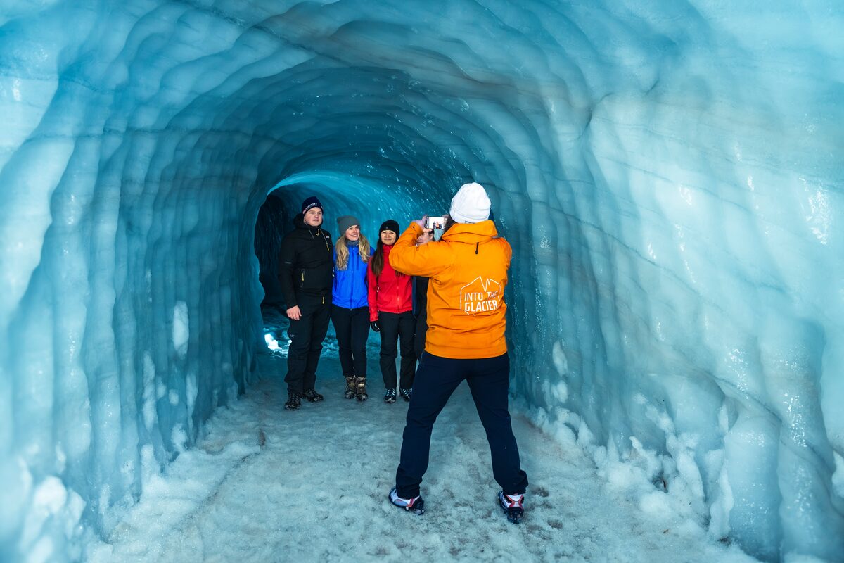 Small group tour posing for photos inside Langjokull ice tunnel 