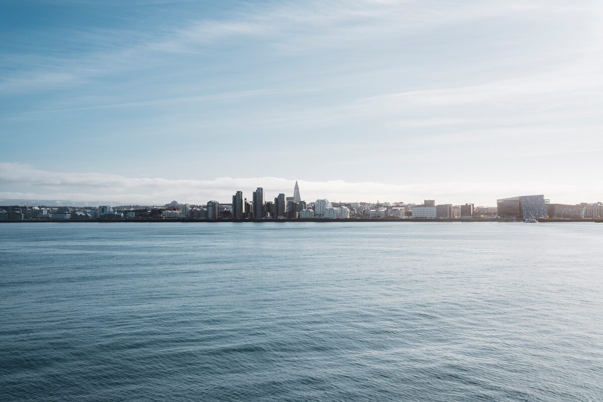 Reykjavik harbor in skyline in distance, view from ocean during summer.