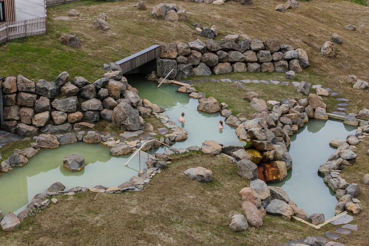 people bathing in a hot springs at highland base