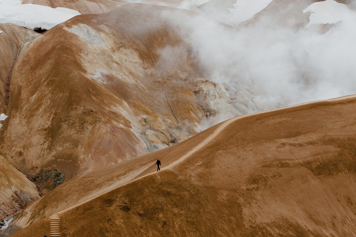a person hiking on hveradalir in iceland
