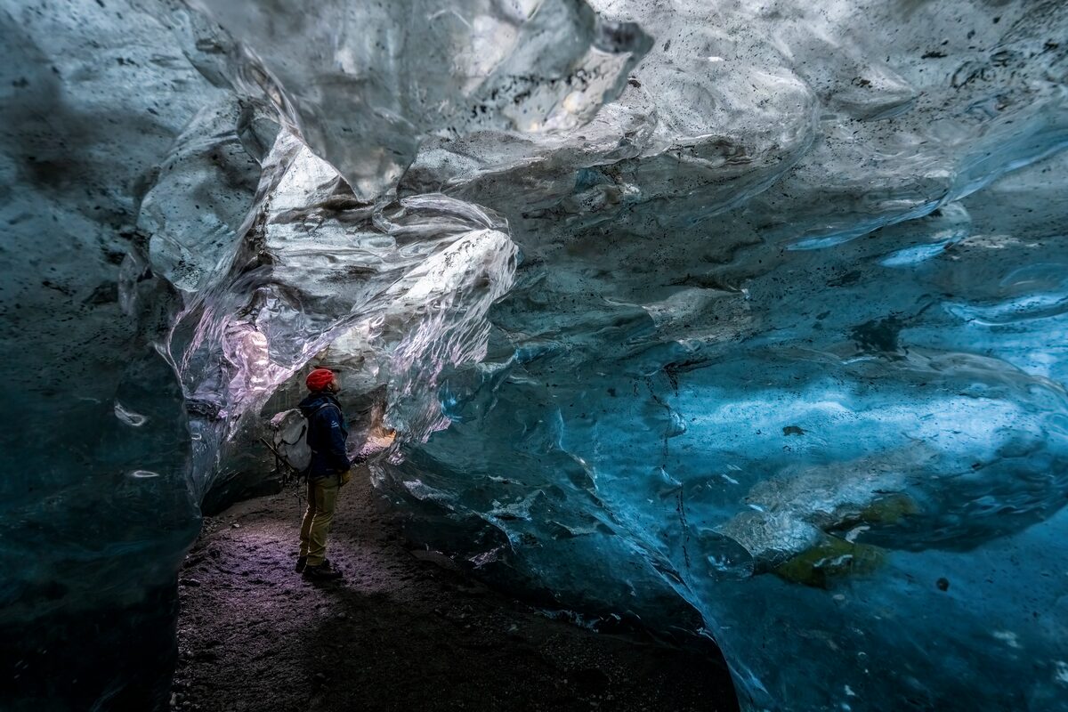 Tourist exploring inside Crystal ice cave in Vatnajokull 2025.