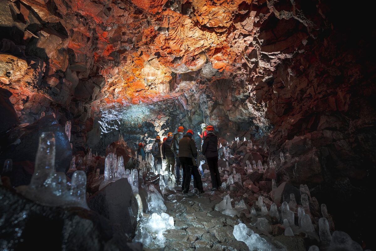Tourists On A Tour In Lava Tunnel In Winter