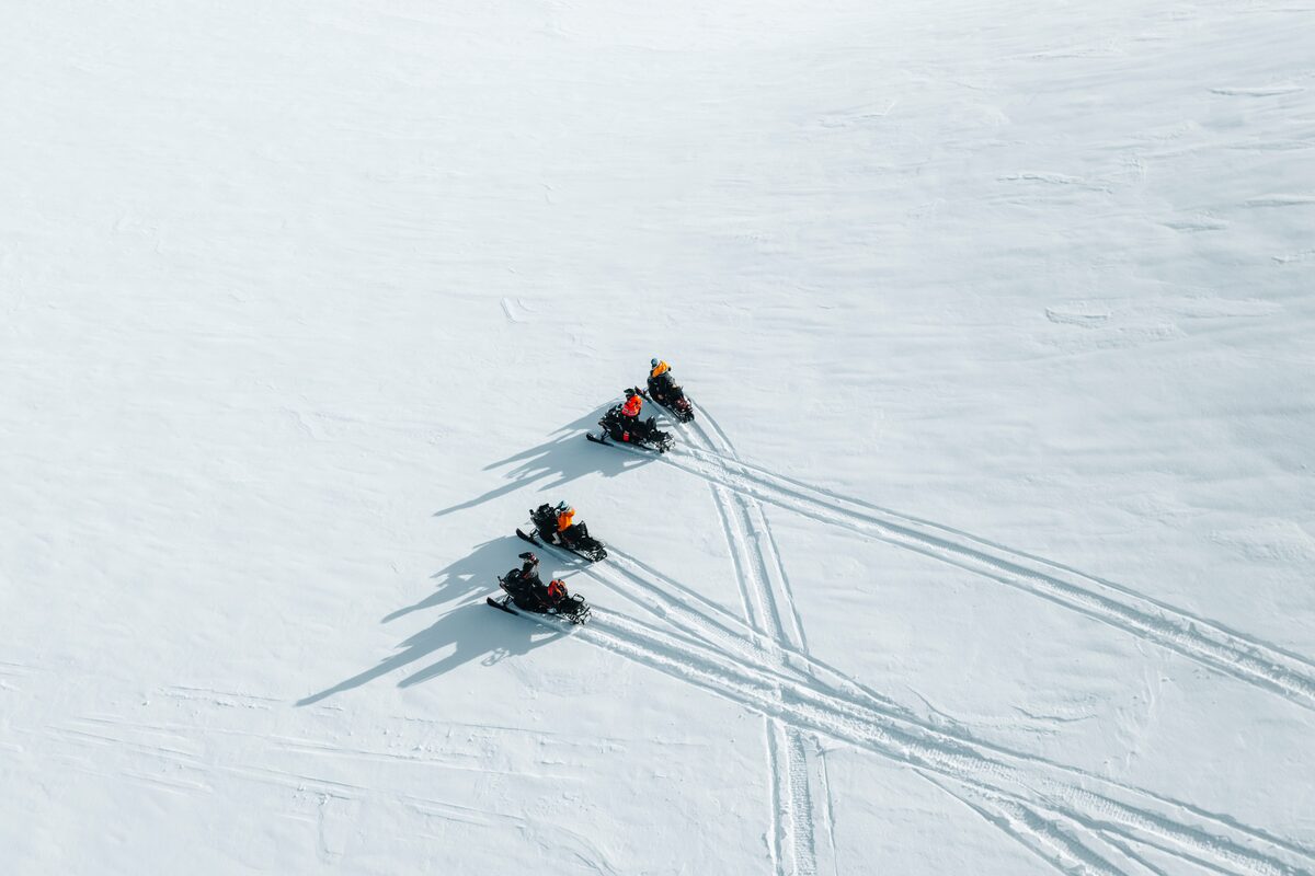 Snowmobiling Experts Driving On A Langjokull Glacier Photographed From Above