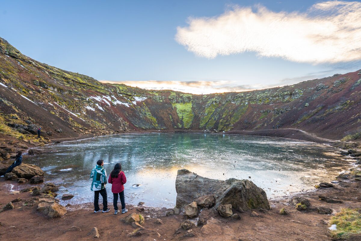 A Couple Standing And Looking At Kerid Crater in iceland