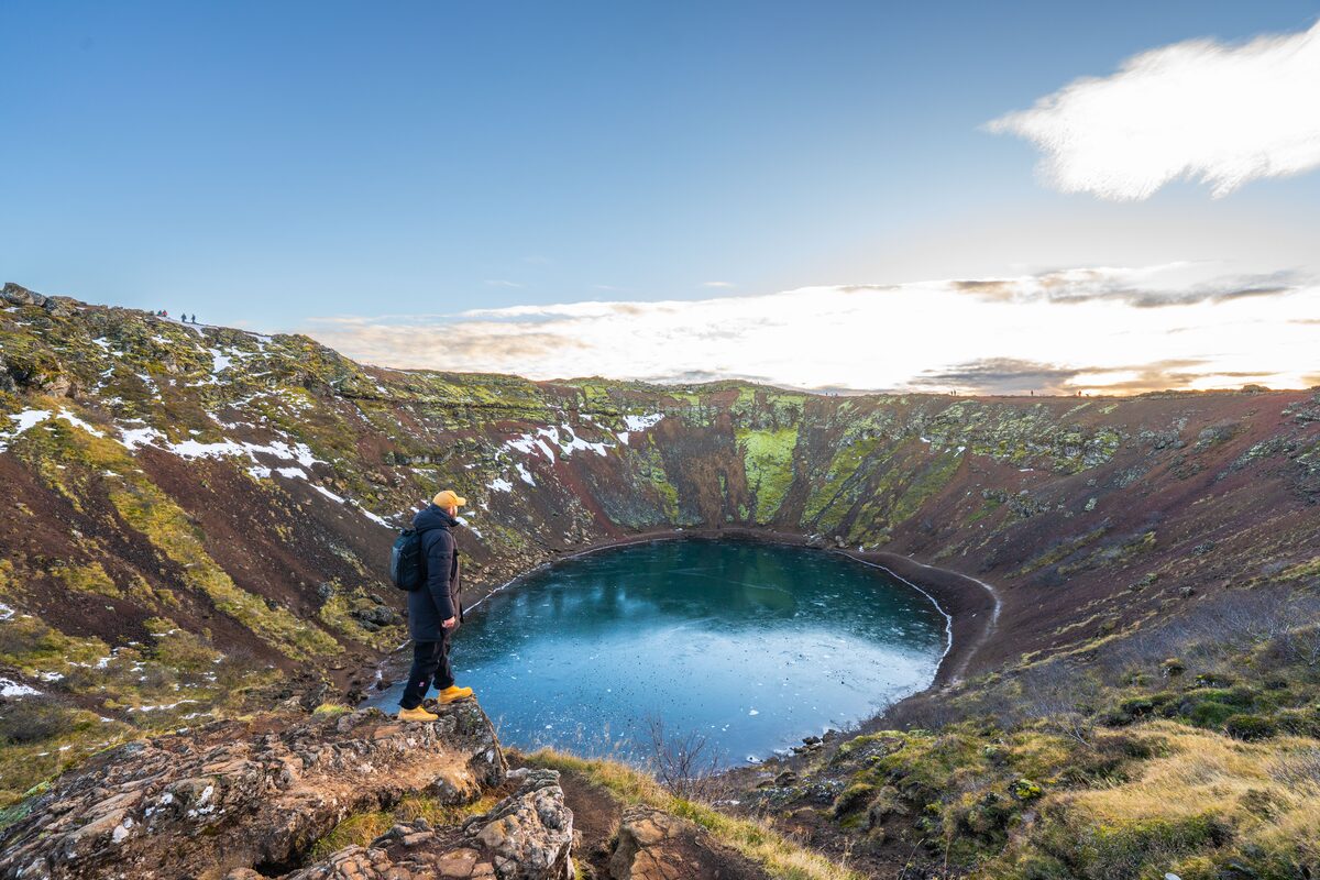 Man Standing On The Edge Of Kerid Crater