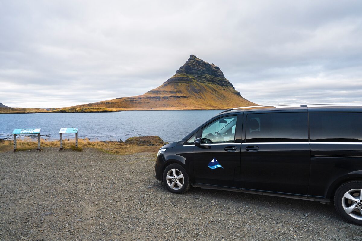 A Car Standing In Front Of Kirkjufell Mountain