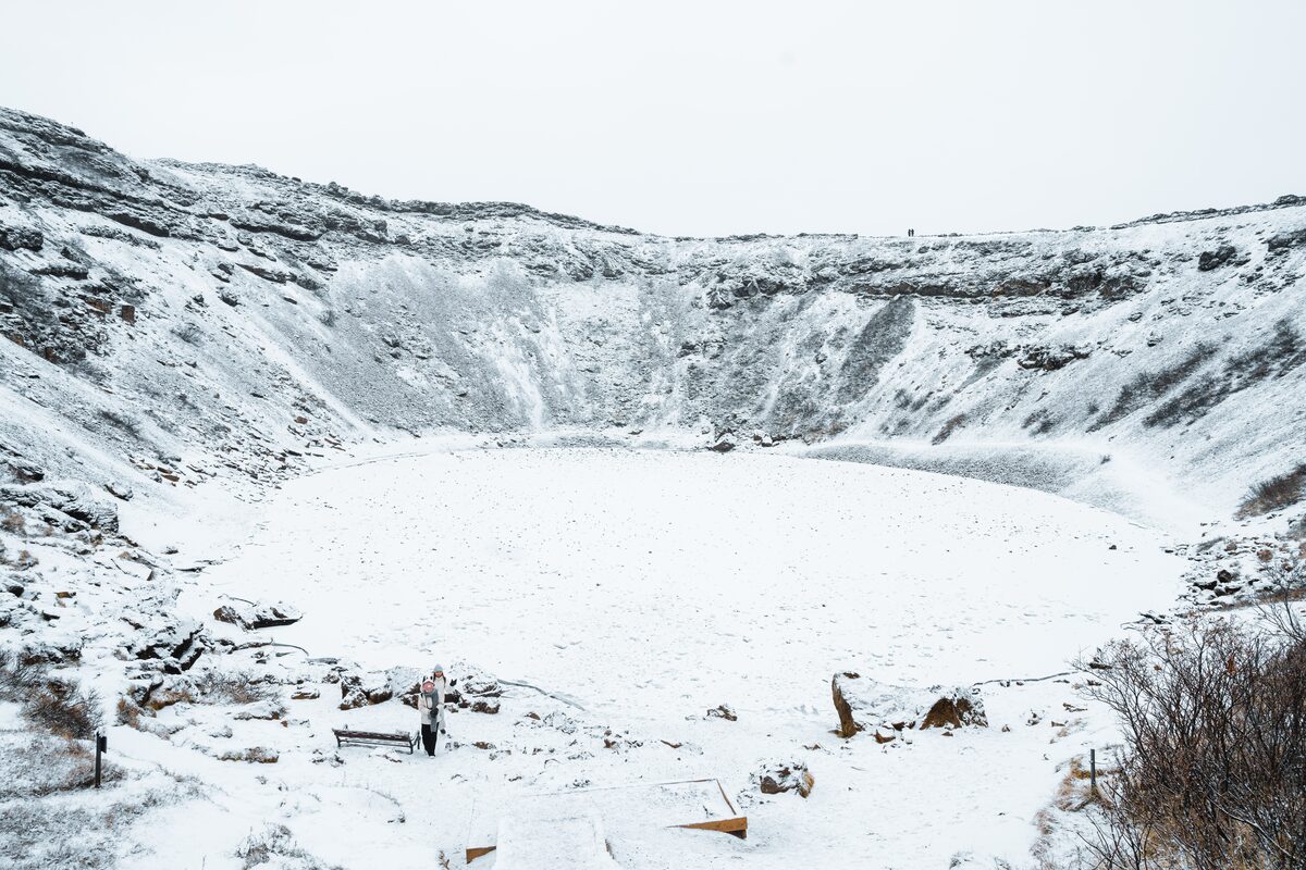 Tourists At Kerid Crater Covered In Snow in Iceland