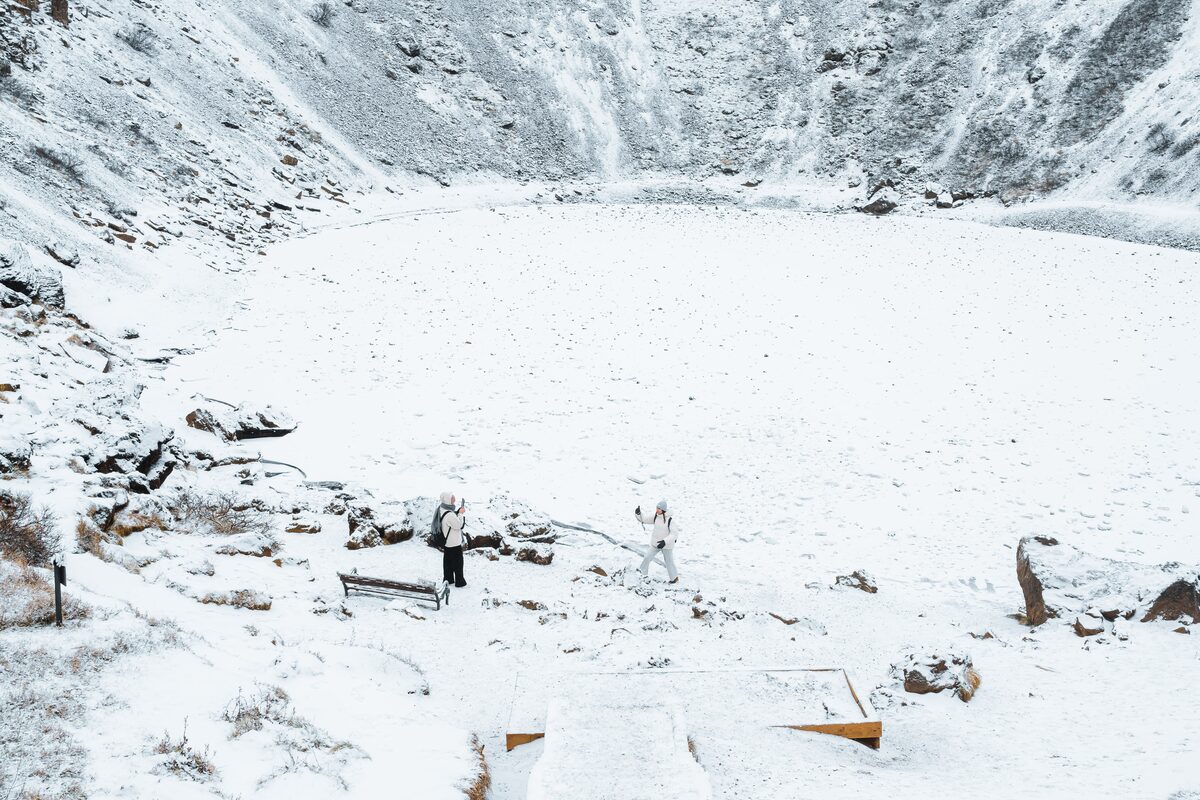 Tourists Taking Pictures Near Snowy Kerid Crater in Iceland