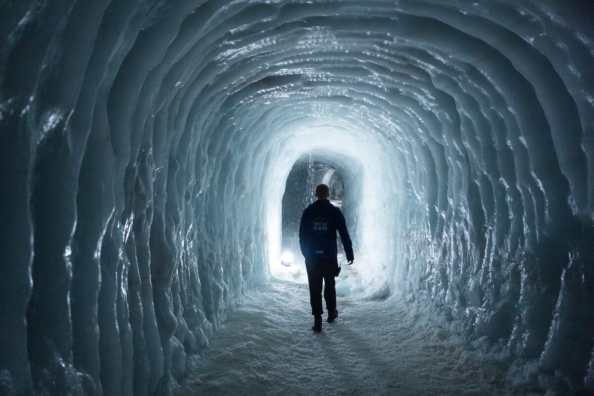 Man Walking In An Ice Tunnel On Langjokull Glacier in iceland