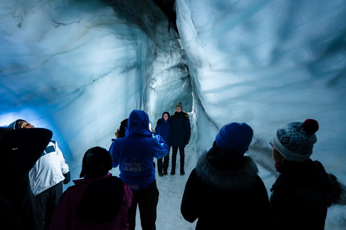 People On Tour At An Ice Tunnel Taking Pictures in iceland