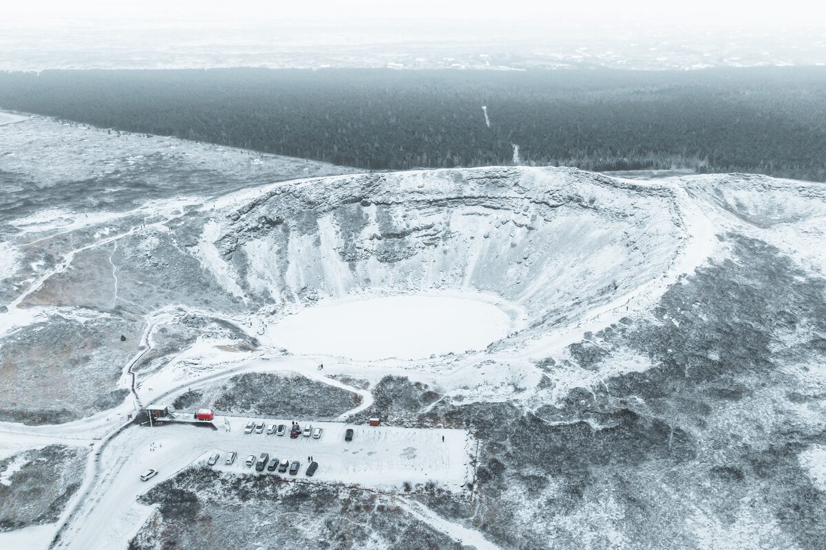 Kerid Crater And A Parking Lot Covered In Snow in iceland