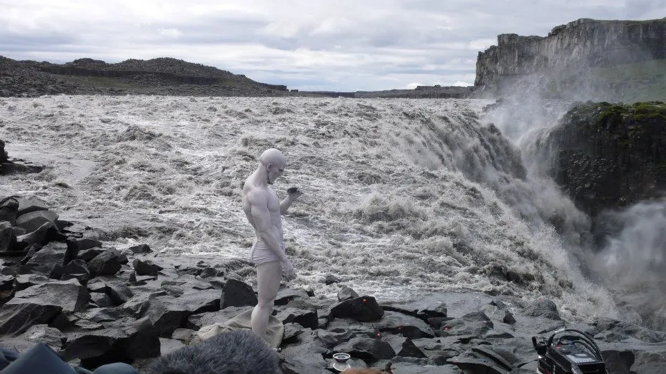 Screenshot from Prometheus (2012) at Dettifoss Waterfall, Iceland, showing a person standing near the rushing river