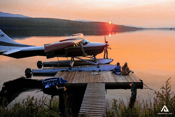 a plane at sunset on a lake
