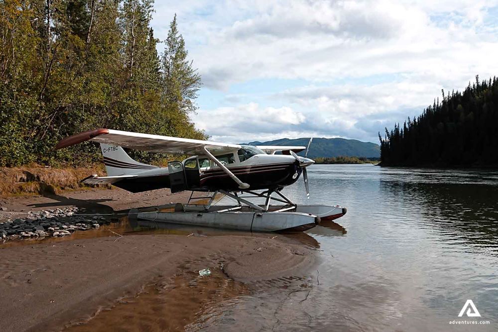 Bushplane landed on the shore of a river