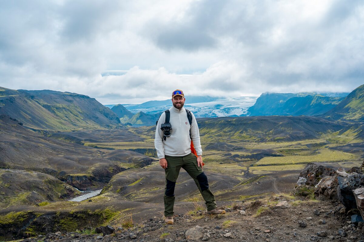 Man In A White Sweater On A Hill At Landmannalaugar in Iceland