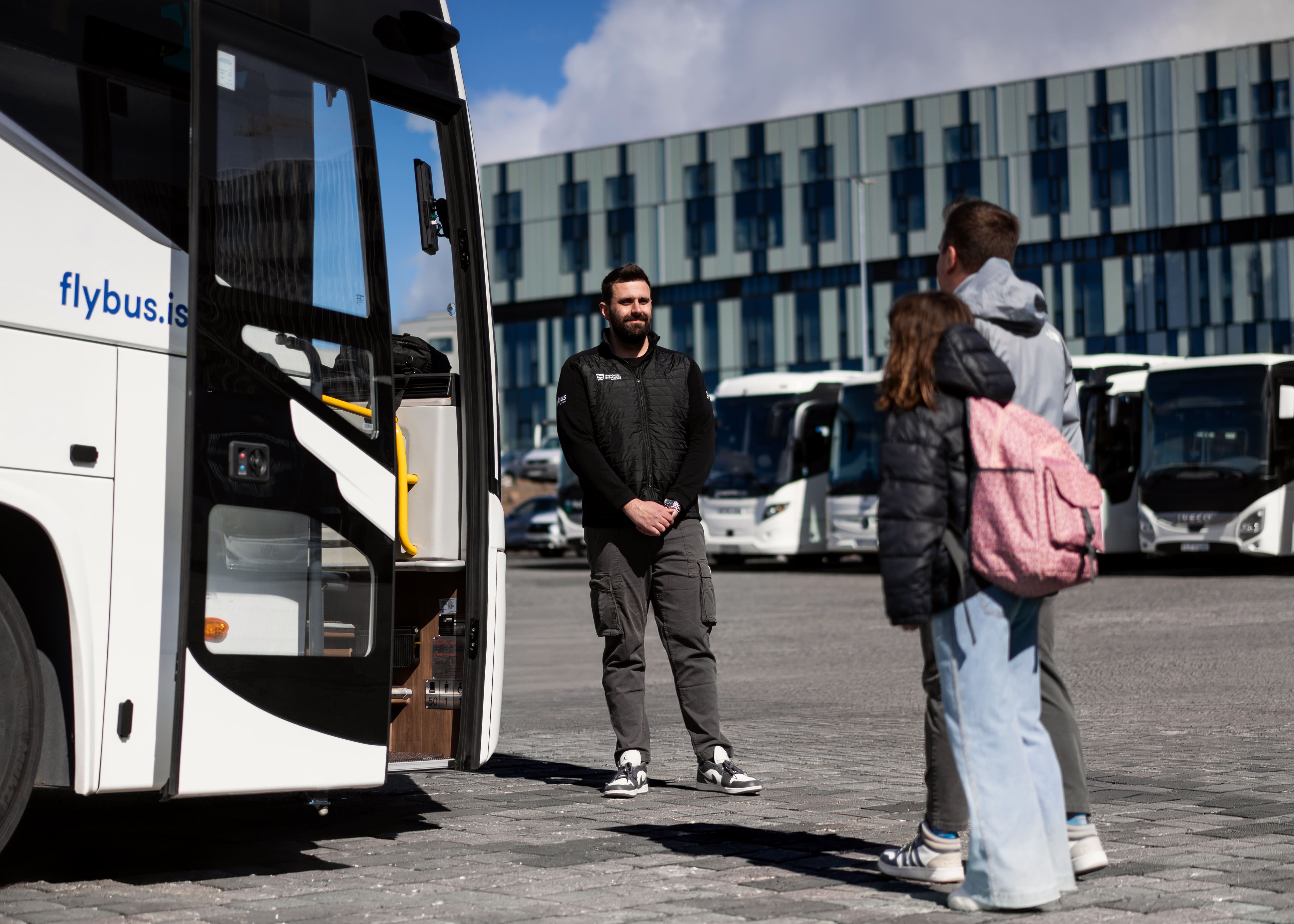 Bus Driver Greeting A Father And Daughter To The Bus in Iceland