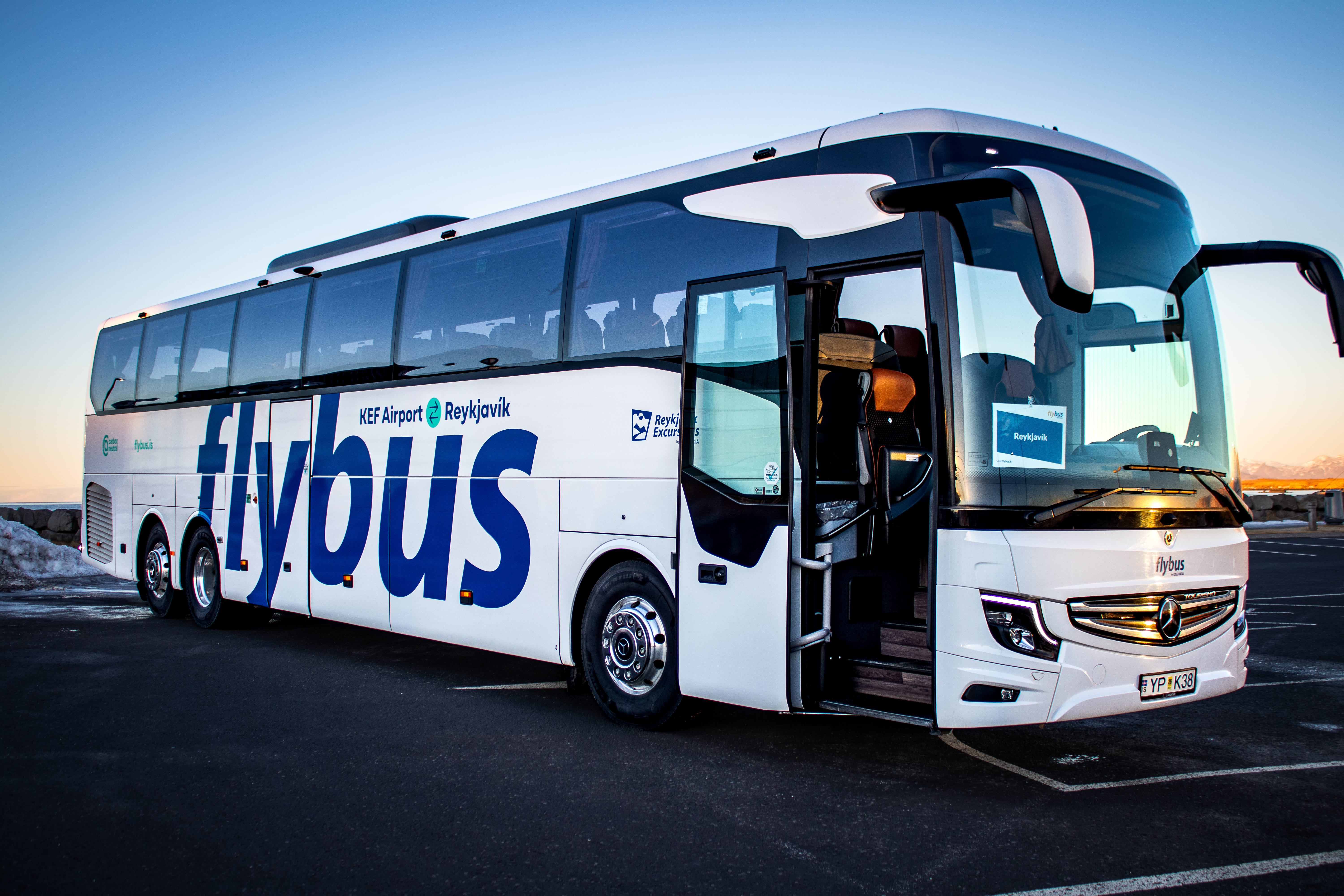 Flybus Bus Standing In A Parking Lot With Its Doors Open in Iceland
