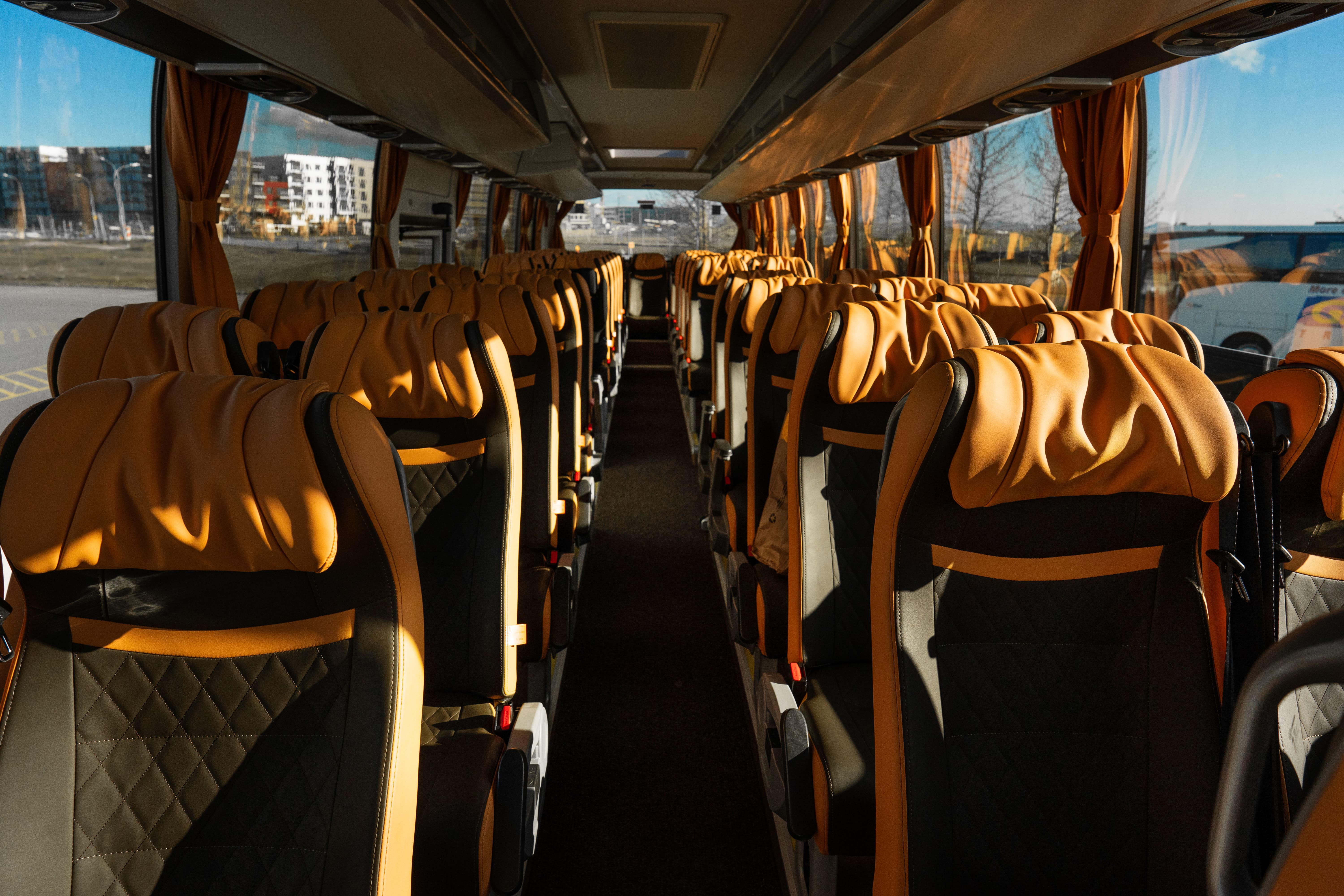 Orange And Black Leather Covered Seats Inside Of A Flybus Bus in Iceland