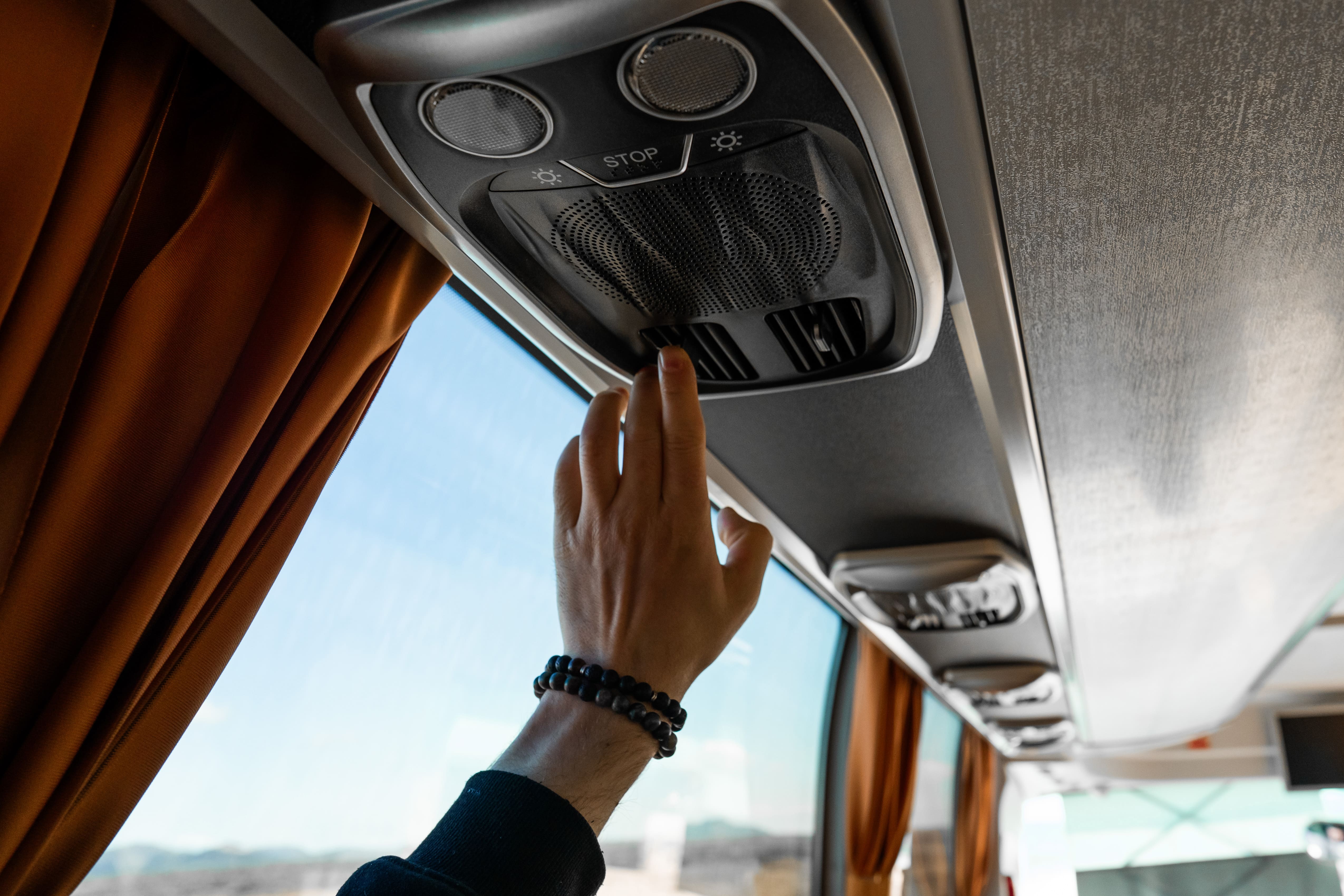 Persons Hand Adjusting The Temperature And Vents Inside The Flybus Bus in Iceland