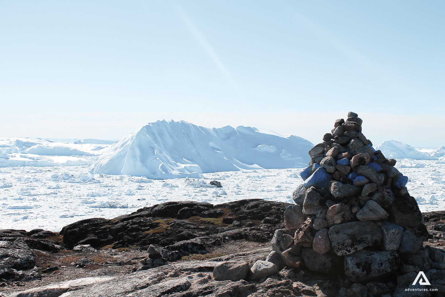 Rocks with iceberg in background