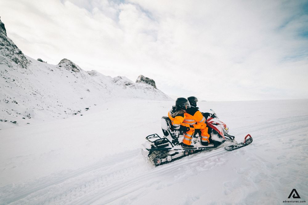 Couple on a snowmobile ride