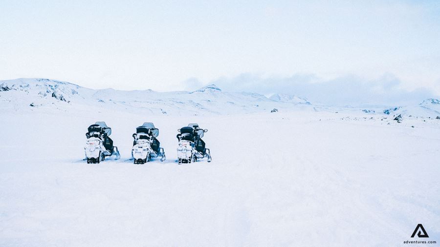 Snowmobiles standing in a row