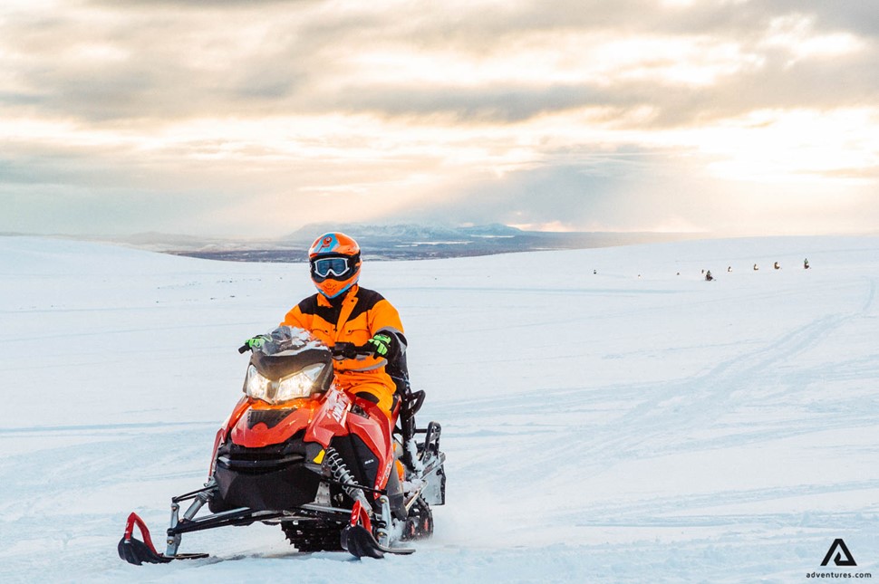 Man on a snowmobile Man driving snowmobile
