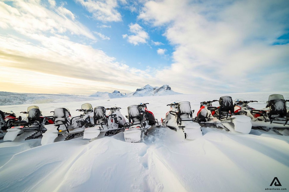 Snowmobiles in a row in snow Snowmobiles in a row