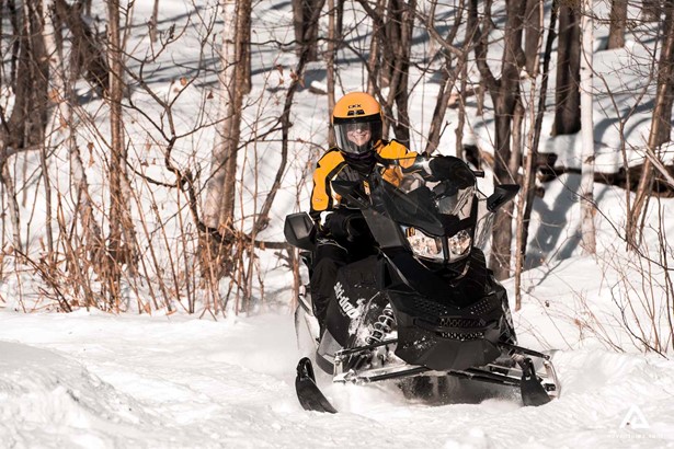 Girl on a snowmobiling tour