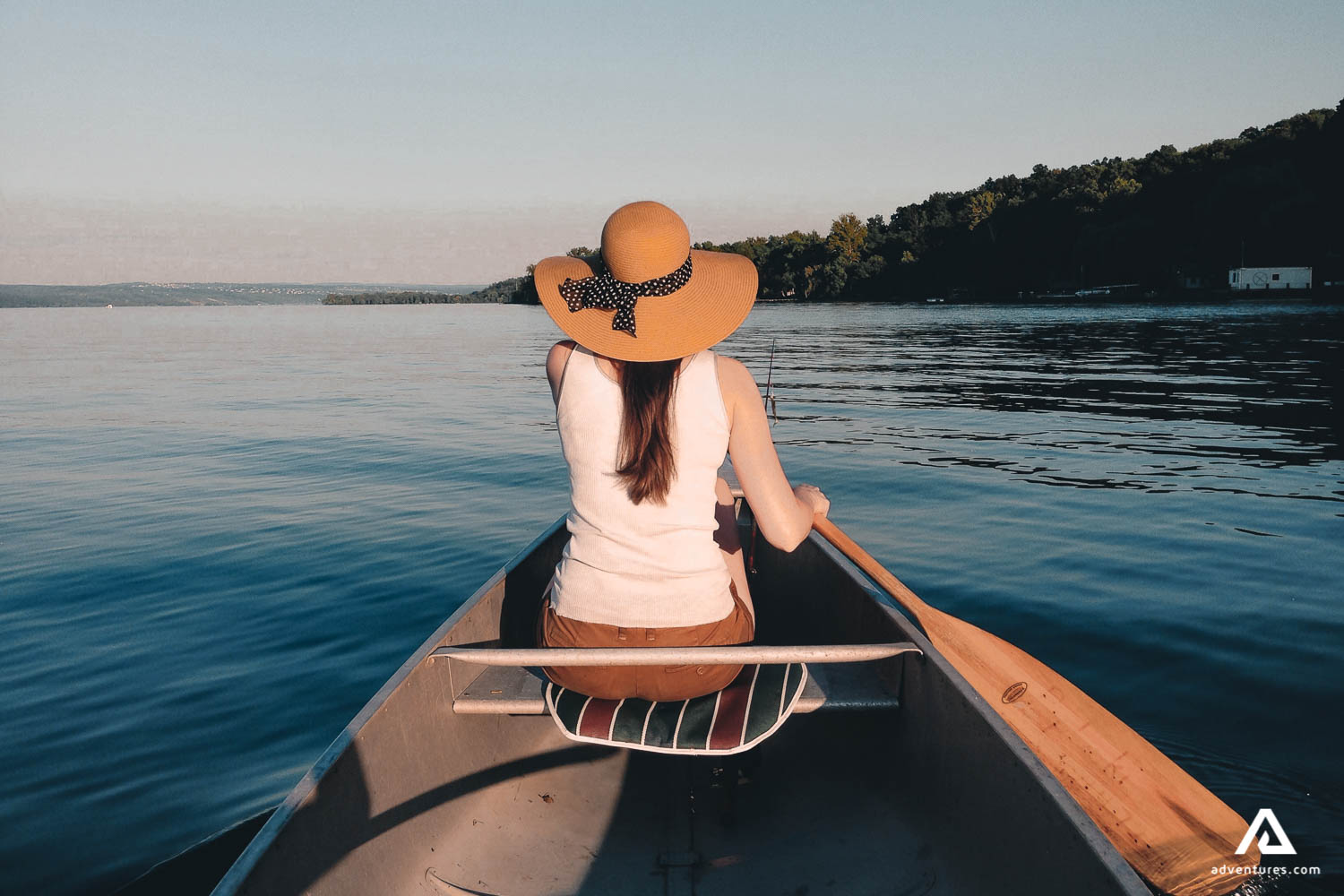 Girl back view canoeing on the Lake