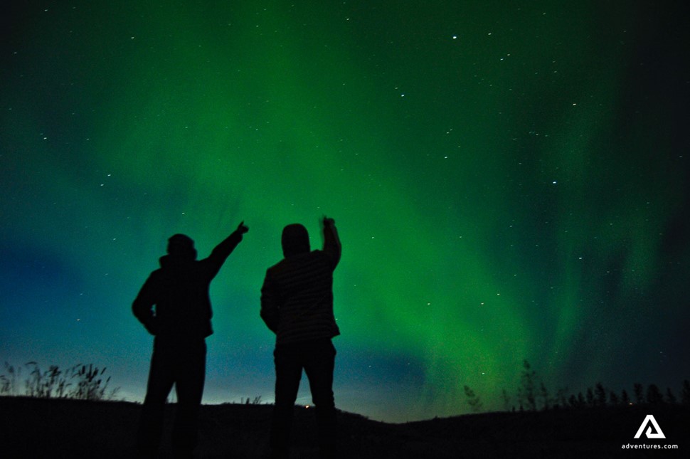 Men enjoying Aurora Borealis