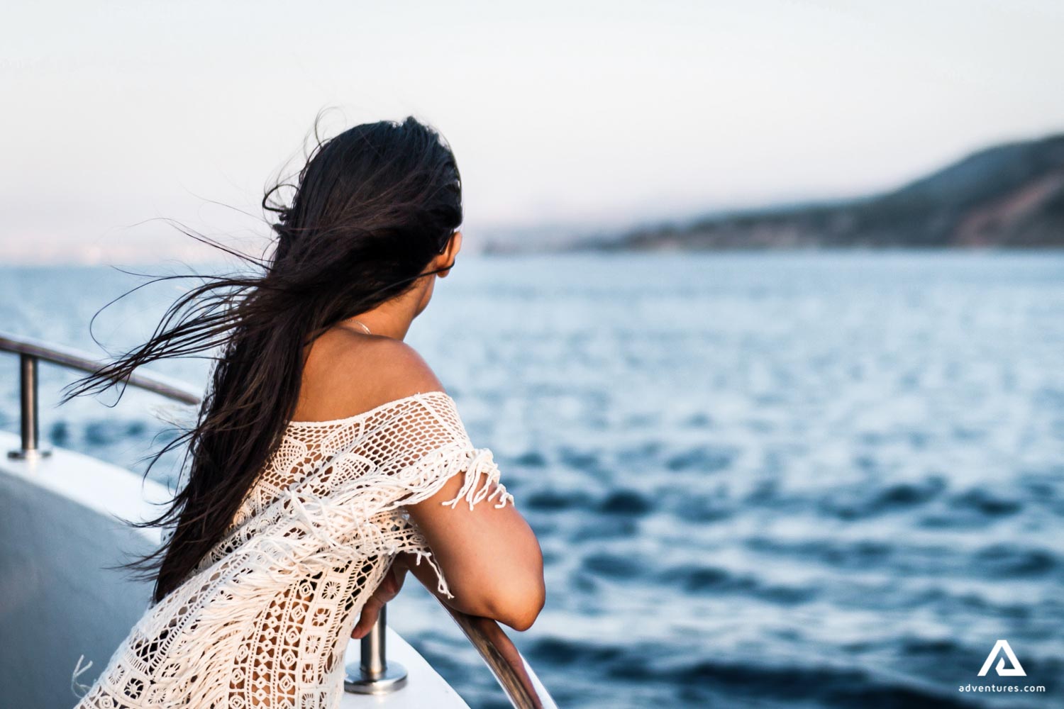 Woman Stands on Deck of Cruise Ship