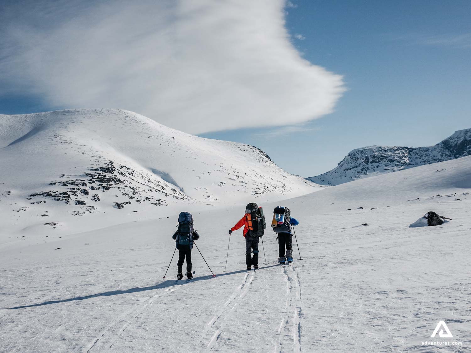 Group of people skiing up the hill