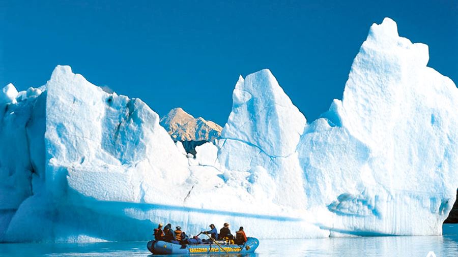 rafting near a large iceberg
