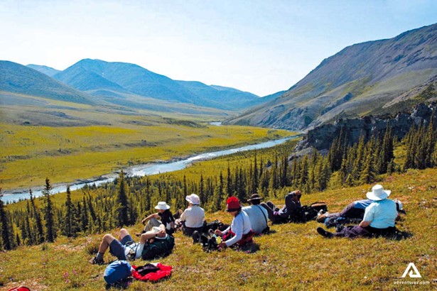 hikers on a hill near firth river in canada
