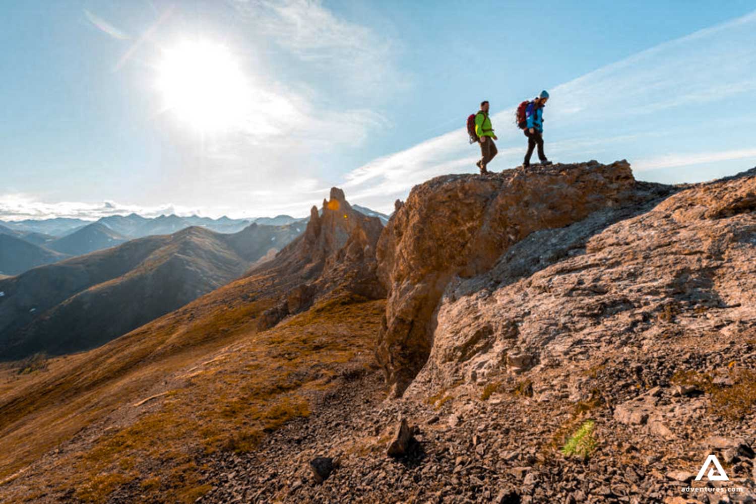 men hiking in the mountains near firth river 