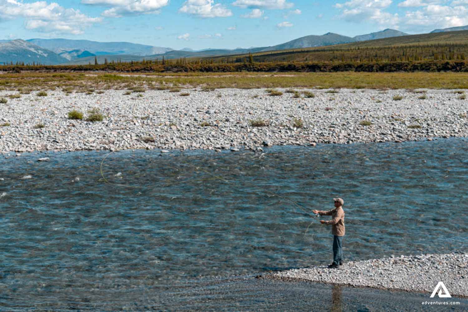 fly fishing at firth river at summer in canada