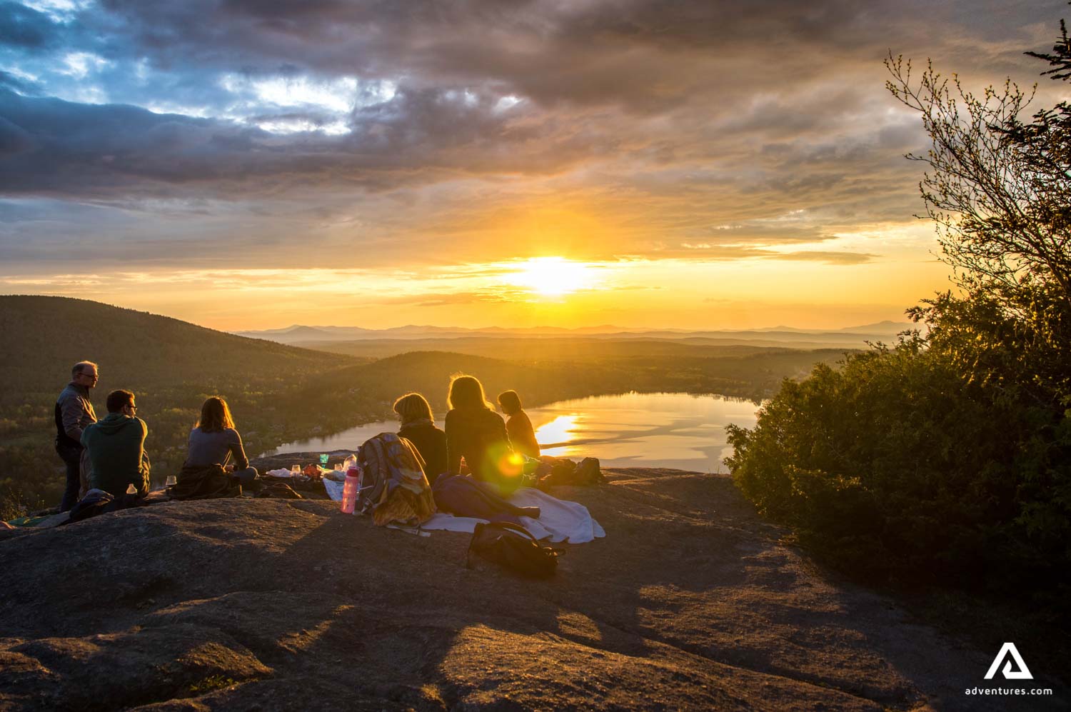 group enjoying a sunset in the mountains