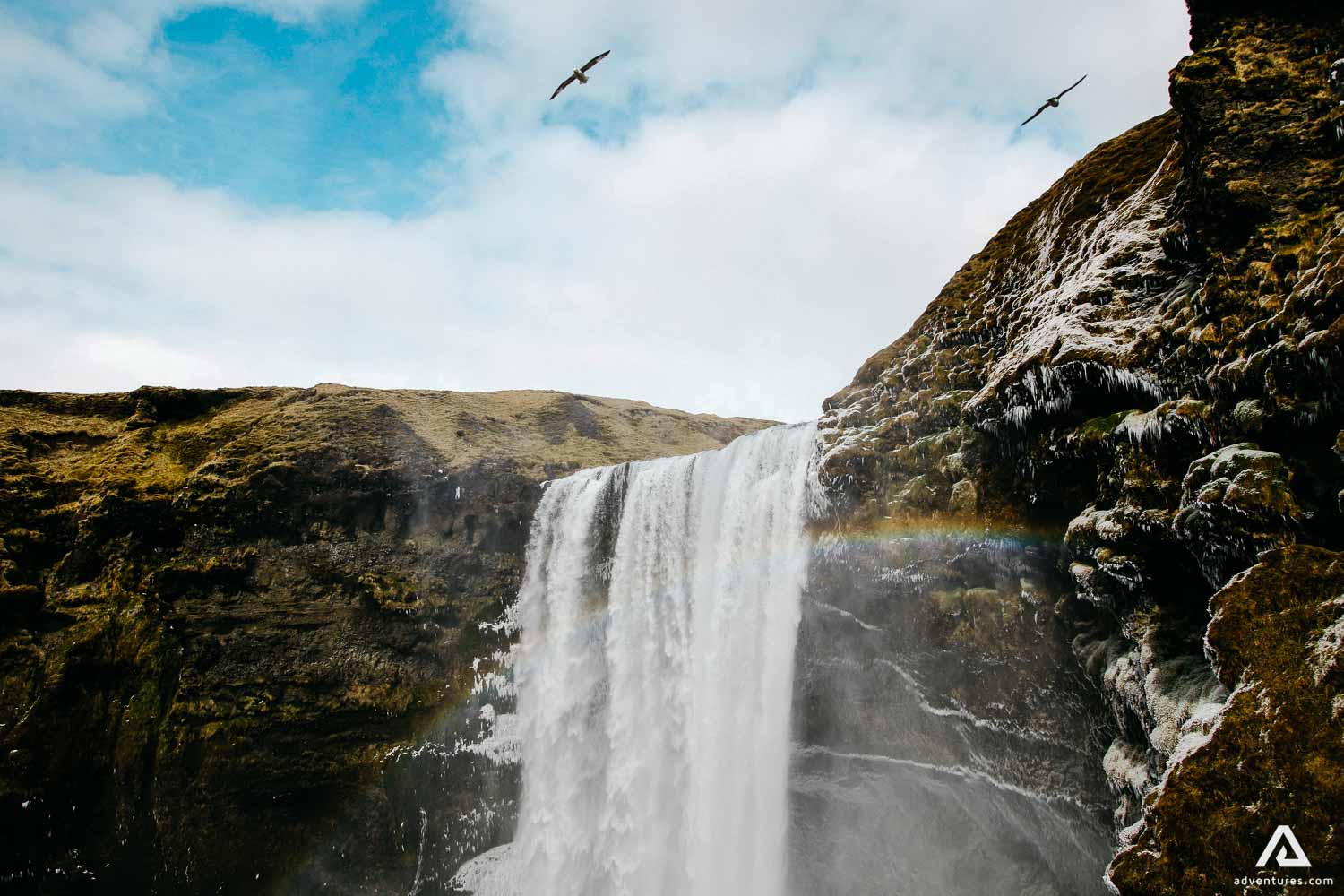 rainbow over skogafoss waterfall in iceland