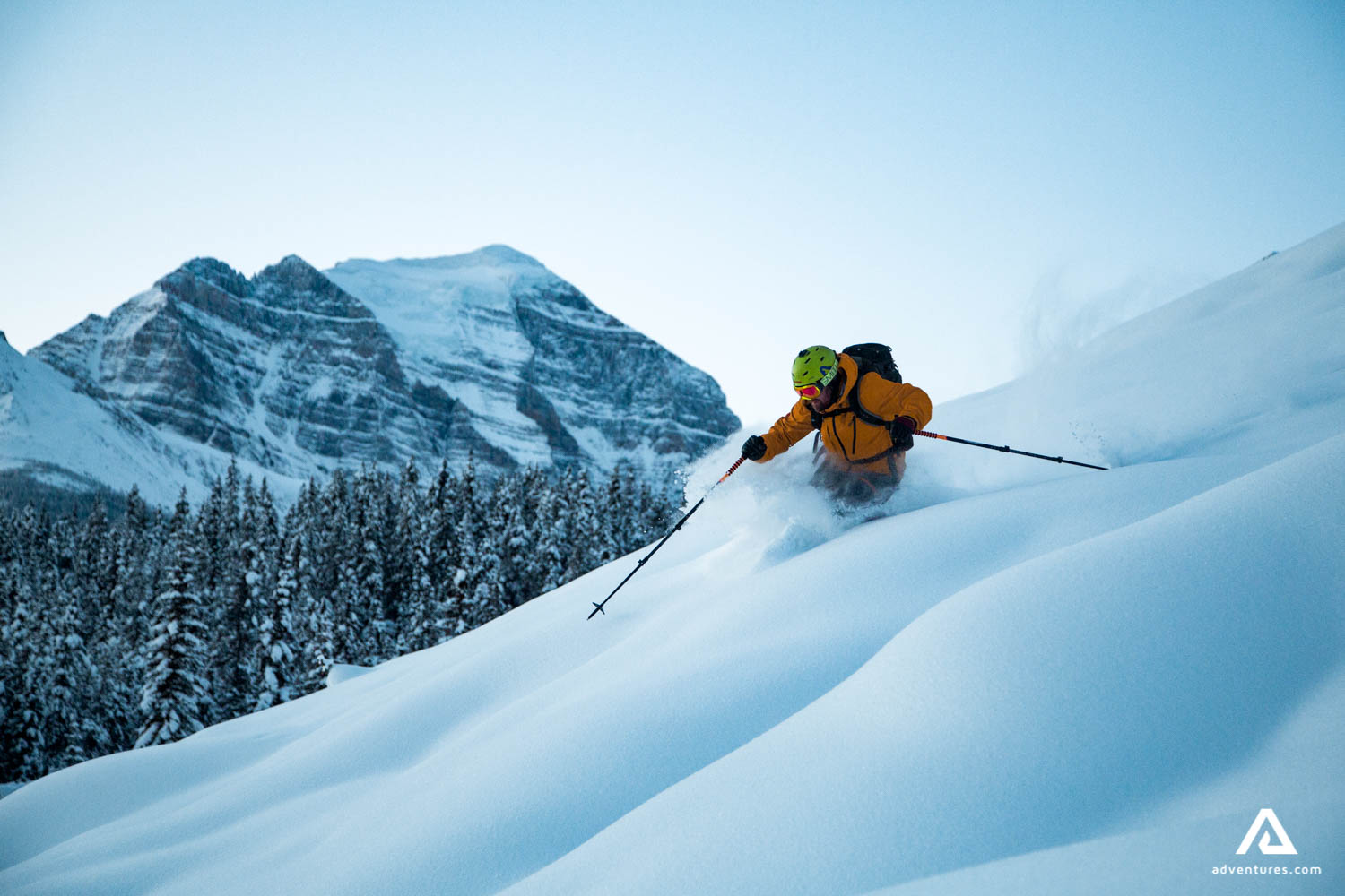 man skiing down a mountain in the evening