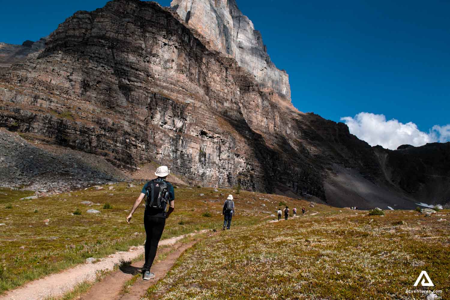 hikers in rocky mountain on a trail