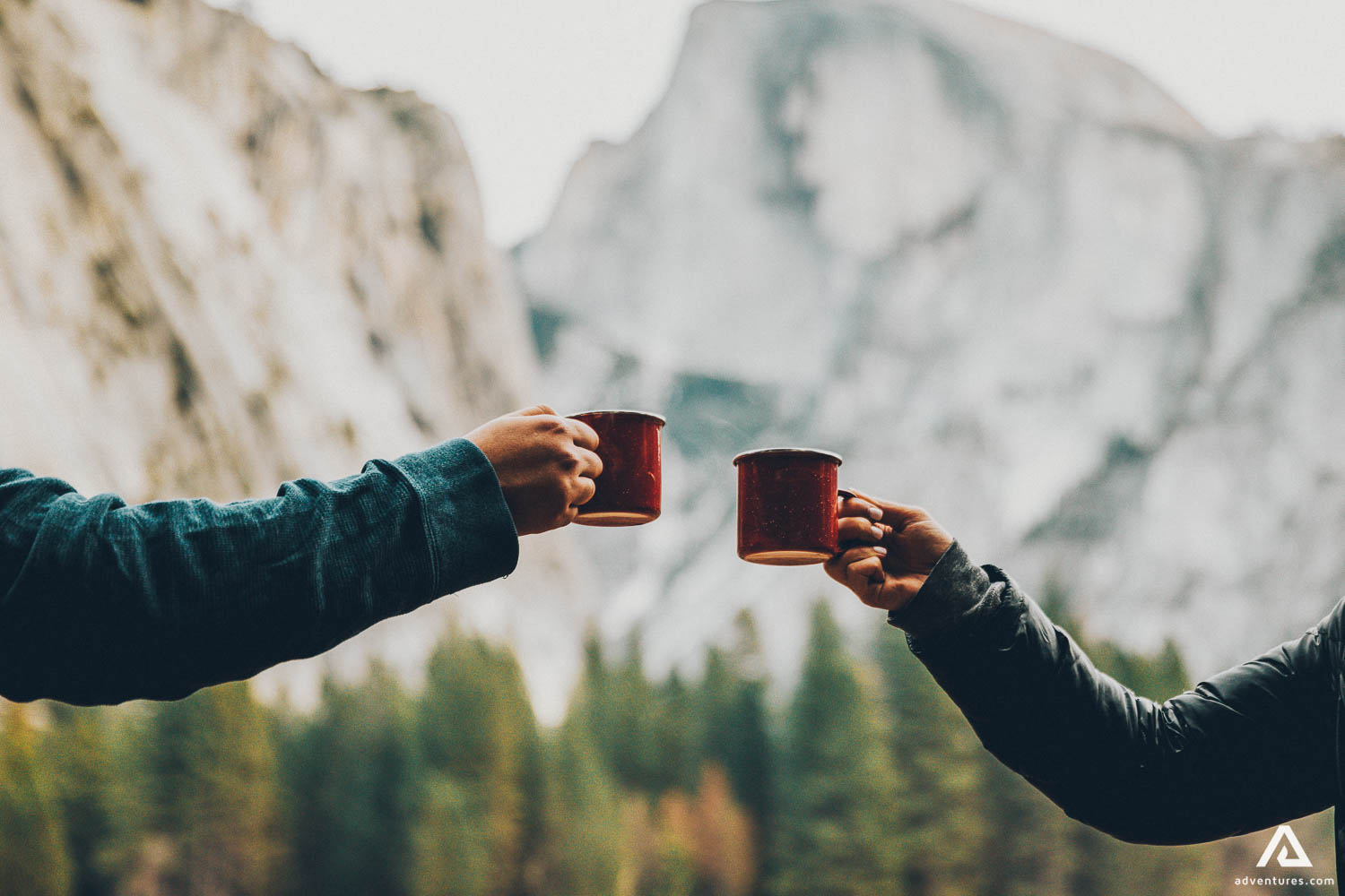 Couple Drinking Tea In Front Of Mountains