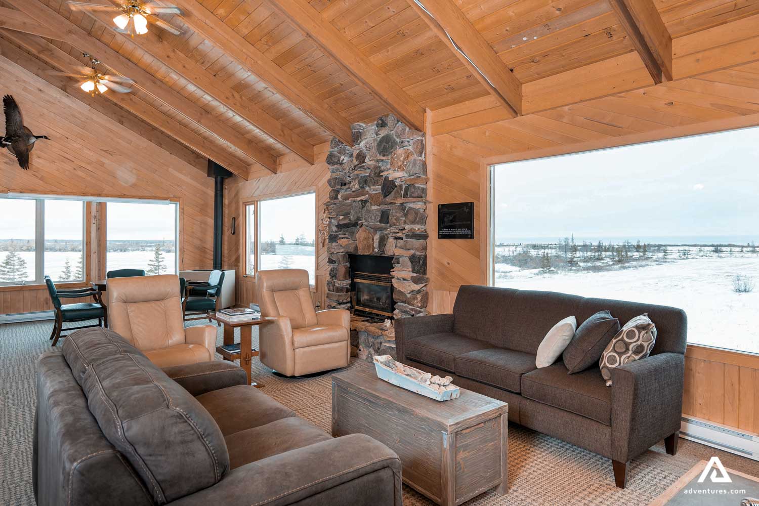 sofas and fireplace inside a lodge building