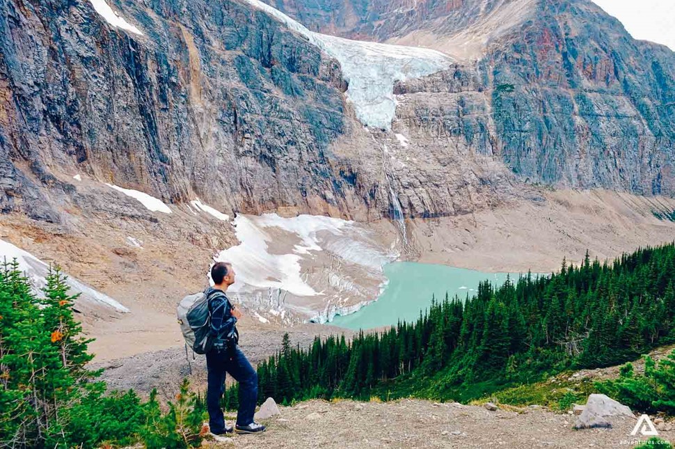 Man Standing In Canada Rockies On Hiking Trail