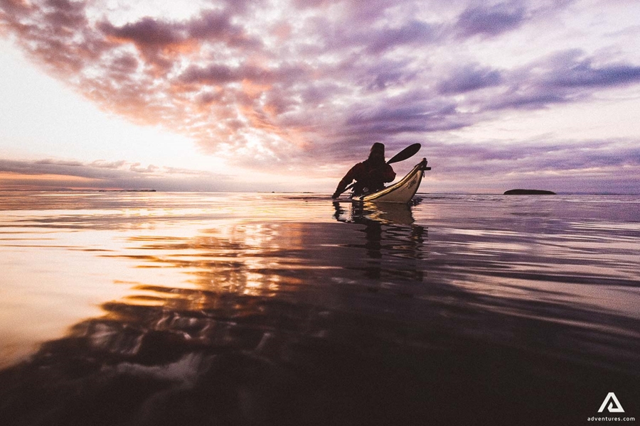 Kayaking tour in the sea at sunset