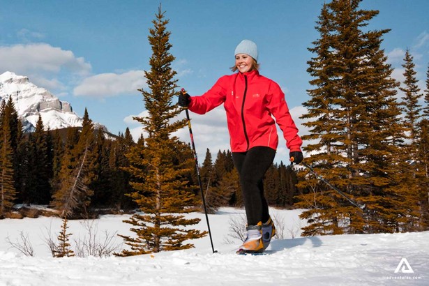 happy woman skiing through countryside