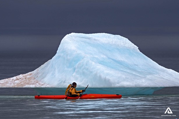 kayaking near large iceberg in somerset island