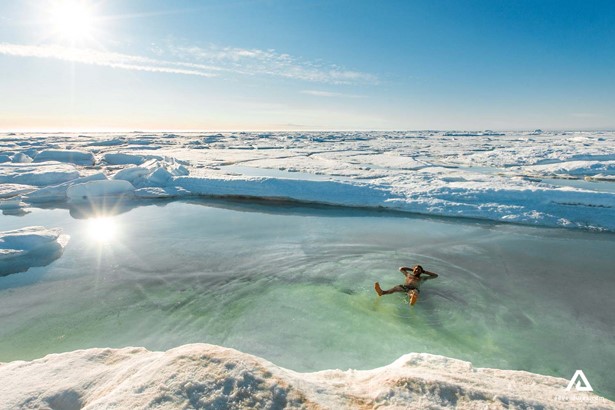 happy man relaxing in glacial water lake