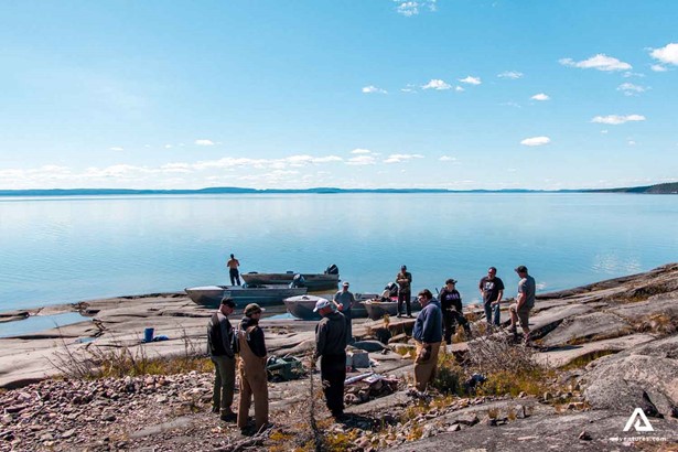 people arriving at great slave lake with boats
