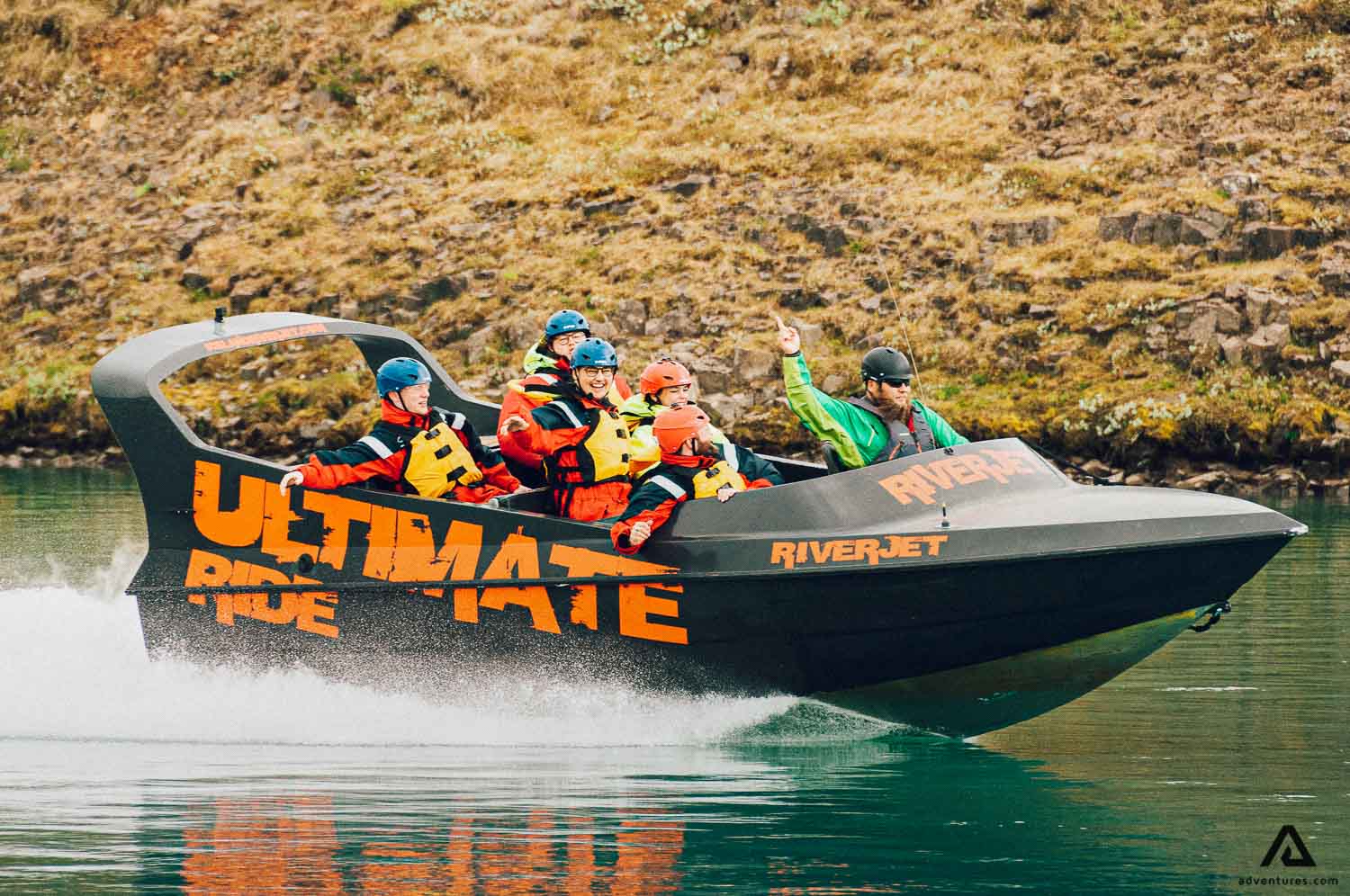 guide waving from a riverjet boat